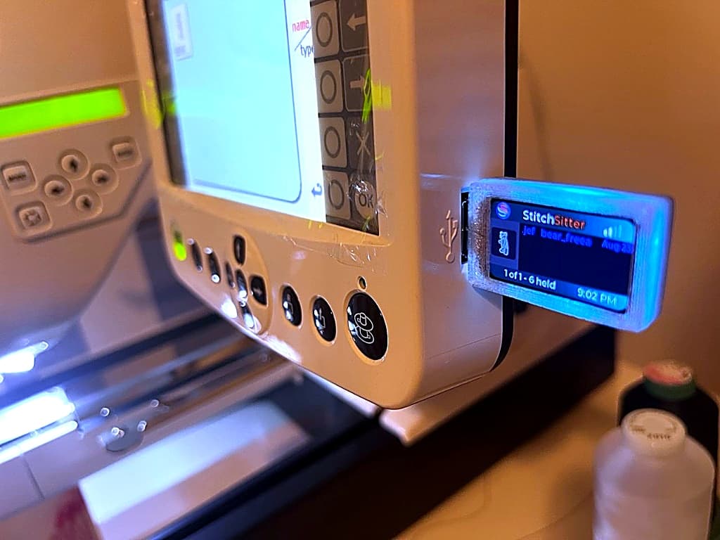 StitchSitter dongle plugged into Janome embroidery machine